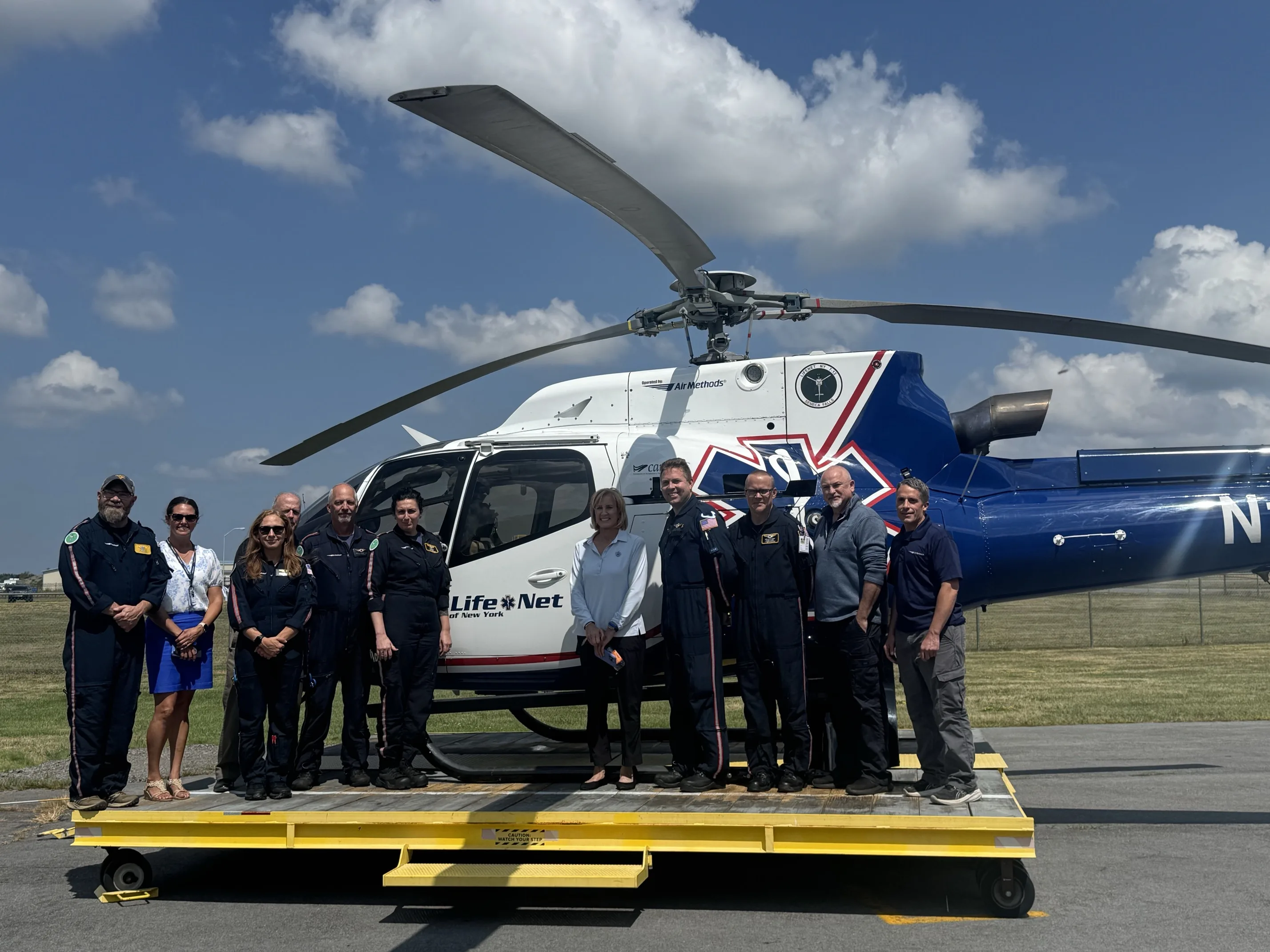 medical helicopter crew standing in front of a helicopter.
